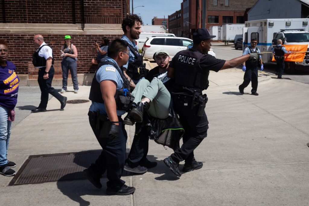 Protestor being carried away by police