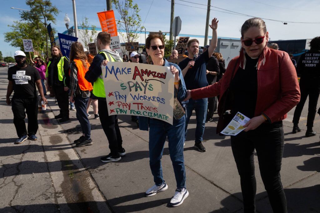 Protesters with signs against Amazon
